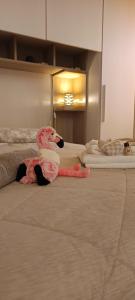 a pink stuffed animal laying on a bed at Casa Il Nido in Cagliari