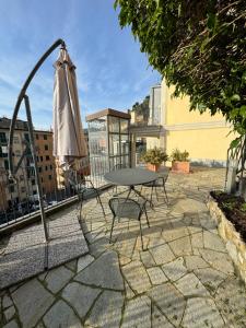 a patio with a table and an umbrella at Appartamenti Michela in Camogli