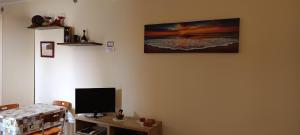 a room with a desk with a computer monitor on a wall at Casa Il Nido in Cagliari