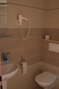 a bathroom with a toilet and a sink at Hotel Klara in Prague