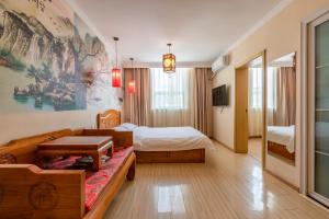 a hotel room with a bed and a couch at Happy Dragon City Center Alley Hotel -In the city center with big window&heater, ticket service&Free Coffee&Food recommendation,Near Tian Anmen Forbiddencity,Easy to get traditional Walking area&Shichahai in Beijing