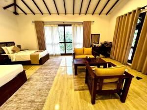 Habitación grande con cama y sofá en Sigiriya Cashew Palace Resort en Daganapothaha