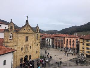 a group of people standing outside of a church at Dúplex Markina Xemein in Marquina