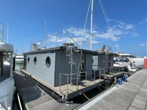 a boat is docked at a dock at Yarmouth Waterlodge Floating Apartments 2 in Yarmouth