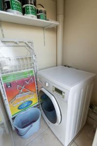 a washer and dryer in a corner of a room at Sun Valley Suite - Hosted by Sweetstay in Mosta