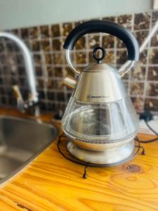 a tea kettle sitting on top of a kitchen counter at Bird Song in Roodepoort