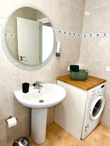 a bathroom with a sink and a washing machine at Hope house Lanzarote in Puerto del Carmen +9 photos