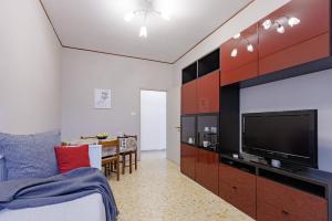 a bedroom with a bed and a tv and a table at Pigneto Smart Apartment in Rome