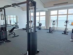 a gym with several treadmills and exercise bikes at Griffen Spa Hotel in Rønne