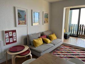 a living room with a couch and a table at Prestige Ocean Apartment - 50 m2 - 2 chambres in Lacanau