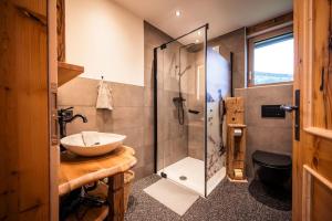 a bathroom with a sink and a shower at Unterkircher Chalet in Arriach