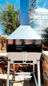 a black and white piano sitting in front of a fence at Pensione Casa da AMIZADE B&B in Pedra Badejo