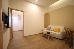a living room with a white couch and a table at Casabella 103 A2 Grand Batam Penuin Wet Market in Nagoya