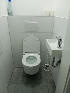 a small bathroom with a toilet and a sink at Lara Zimmer in Heilbronn Zentrum in Heilbronn