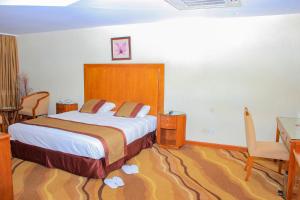 Postel nebo postele na pokoji v ubytování Mbale Resort Hotel