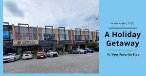 a holiday getaway sign with cars parked in front of a building at EASY HOMESTAY LUKUT NS in Port Dickson