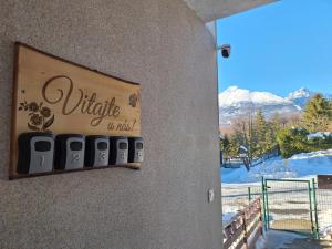 a sign on a wall with a view of a mountain at Privat Tatry Dreams in Nová Lesná