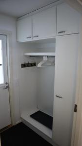 a kitchen with white cabinets and a refrigerator at Keskuskarintie 9 A3 in Kalajoki