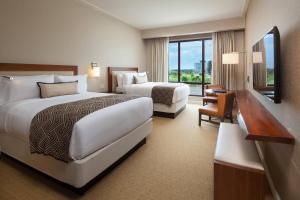 a hotel room with two beds and a window at The Santa Maria, a Luxury Collection Hotel & Golf Resort, Panama City in Panama City
