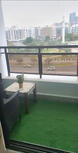 a room with a table and a window with green grass at Heart of Abu Dhabi - Wonder Balcony Room in Abu Dhabi