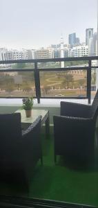 a balcony with a table and chairs and a view of a city at Heart of Abu Dhabi - Wonder Balcony Room in Abu Dhabi