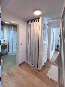a white bathroom with a shower and a toilet at Ferienwohnung Tännle in Rust +17 photos