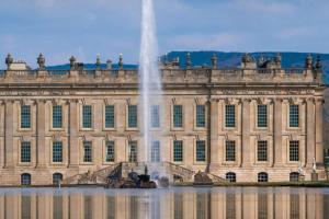 a large building with a fountain in front of it at Beautiful Baslow Bolthole (close to Chatsworth) in Baslow