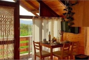 a dining room with a table and chairs and a window at The Treevilla in Protópappas