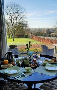 a table with food on it with a view of a yard at B&B Gellick in Lanaken