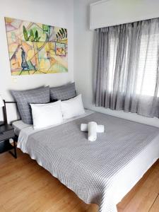 a bedroom with a large bed with a large window at Athens Centre Acropolis "Sunny" apartment #715 in Athens