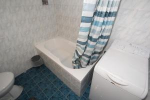 a bathroom with a tub and a toilet and a shower curtain at Athens Centre Acropolis "Sunny" apartment #715 in Athens