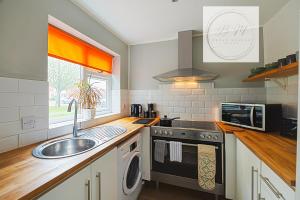 a kitchen with a sink and a stove at Popular Contractor 2-Bed House in Lincoln in Lincoln