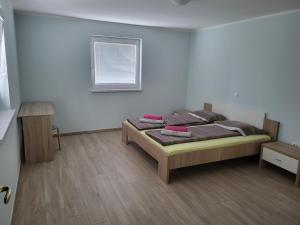 a bedroom with a bed and a window at apartma jermol in Most na Soči