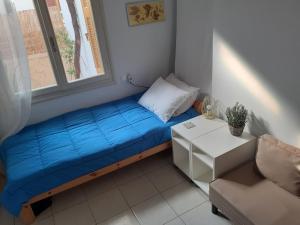 a small bed in a room with a window at Kampos Rooms in Palaiochora