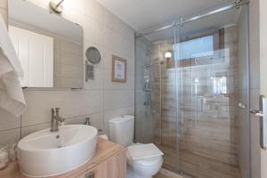 希羅皮加多的住宿－Paralio Astros Beachfront Suites，浴室配有卫生间、盥洗盆和淋浴。