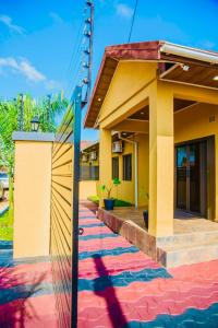 a house with a colorful sidewalk in front of it at Z Apartment (4bedroom) in Lusaka