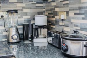 a kitchen counter with a blender and appliances on it at Z Apartment (4bedroom) in Lusaka