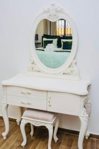 a white dresser with a mirror on top of it at Z Apartment (4bedroom) in Lusaka