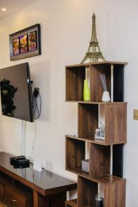 a book shelf with a desk and a tower on it at Z Apartment (4bedroom) in Lusaka