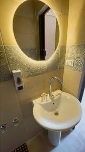 a bathroom with a sink and a mirror at Sami Holiday Inn - pyramids view Rooftop in Cairo