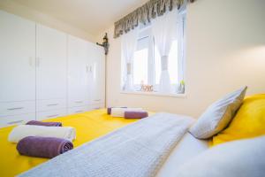 a bedroom with a large bed and a window at Apartment Sacramento centar Varaždin in Varaždin