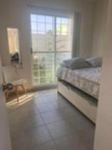 a bedroom with a bed and a window at Casa Jacome in Acapulco