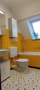 a bathroom with a toilet and a sink and a window at Ferienwohnung Landmann in Winsen Aller