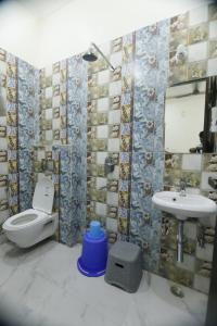 a bathroom with a toilet and a sink at Vraj waas in Mathura