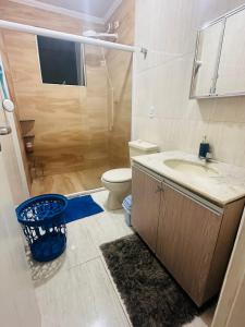 a bathroom with a shower and a sink and a toilet at A casa azul em frente a praia ambiente familiar in Guarujá