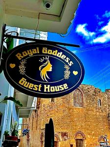 a sign for a first house in front of a building at Royal Goddess Guest House, Walled City in Famagusta