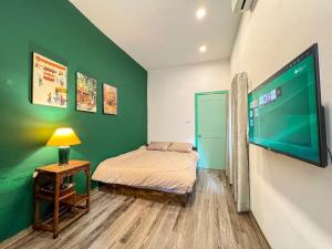 a bedroom with a bed and a flat screen tv at Home4u in Hanoi