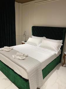 a bedroom with a large bed with white and green at Apart-Hotel Vasilisa EVN Airport in Pʼarakʼar