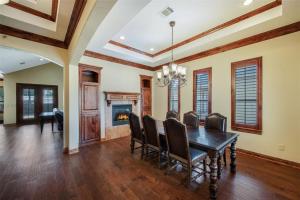 a dining room with a table and chairs and a fireplace at Grapevine Luxury Home in Grapevine