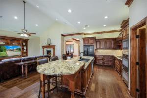 a kitchen with wooden cabinets and a large island at Grapevine Luxury Home in Grapevine